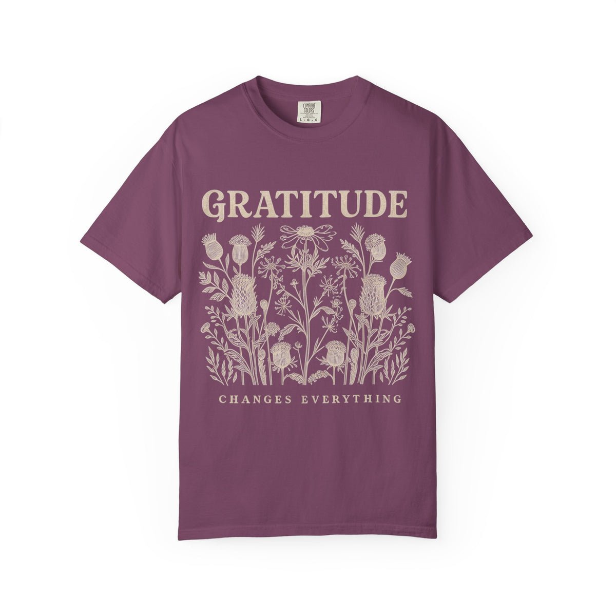 A purple short-sleeve t-shirt with a stylized gratitude graphic across the chest in white, yellow, and purple, displayed on a clean white background.