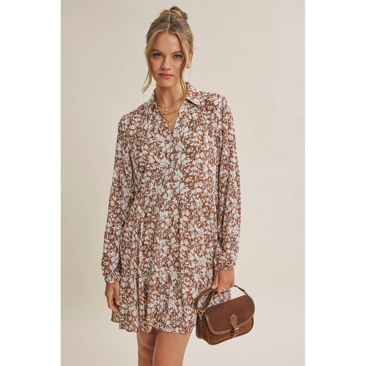 Front view of the mocha and cream Soft Autumn button-down mini dress, styled with a brown handbag.