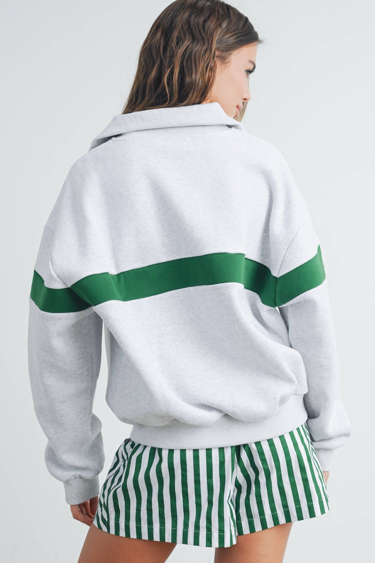 Back view of grey sweatshirt with green stripe