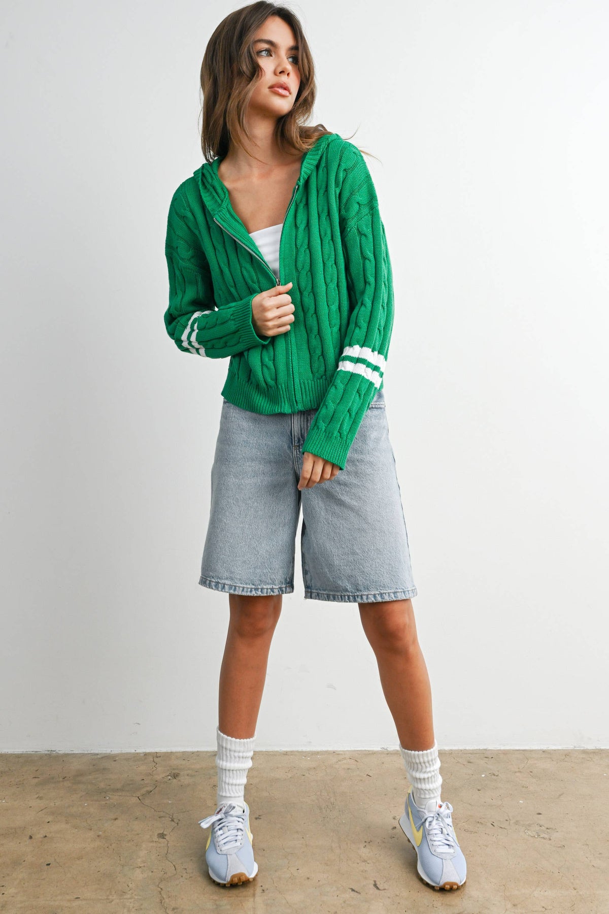 Green cable-knit zip-up hoodie cardigan with ivory sleeve stripes, front outfit view