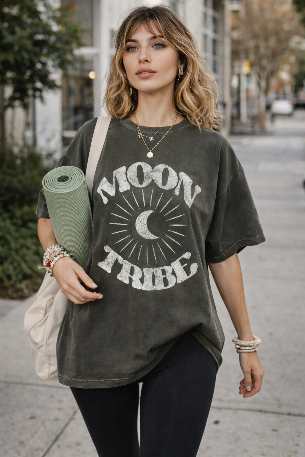 Woman wearing Moon Tribe Pepper graphic tee on the way to yoga class