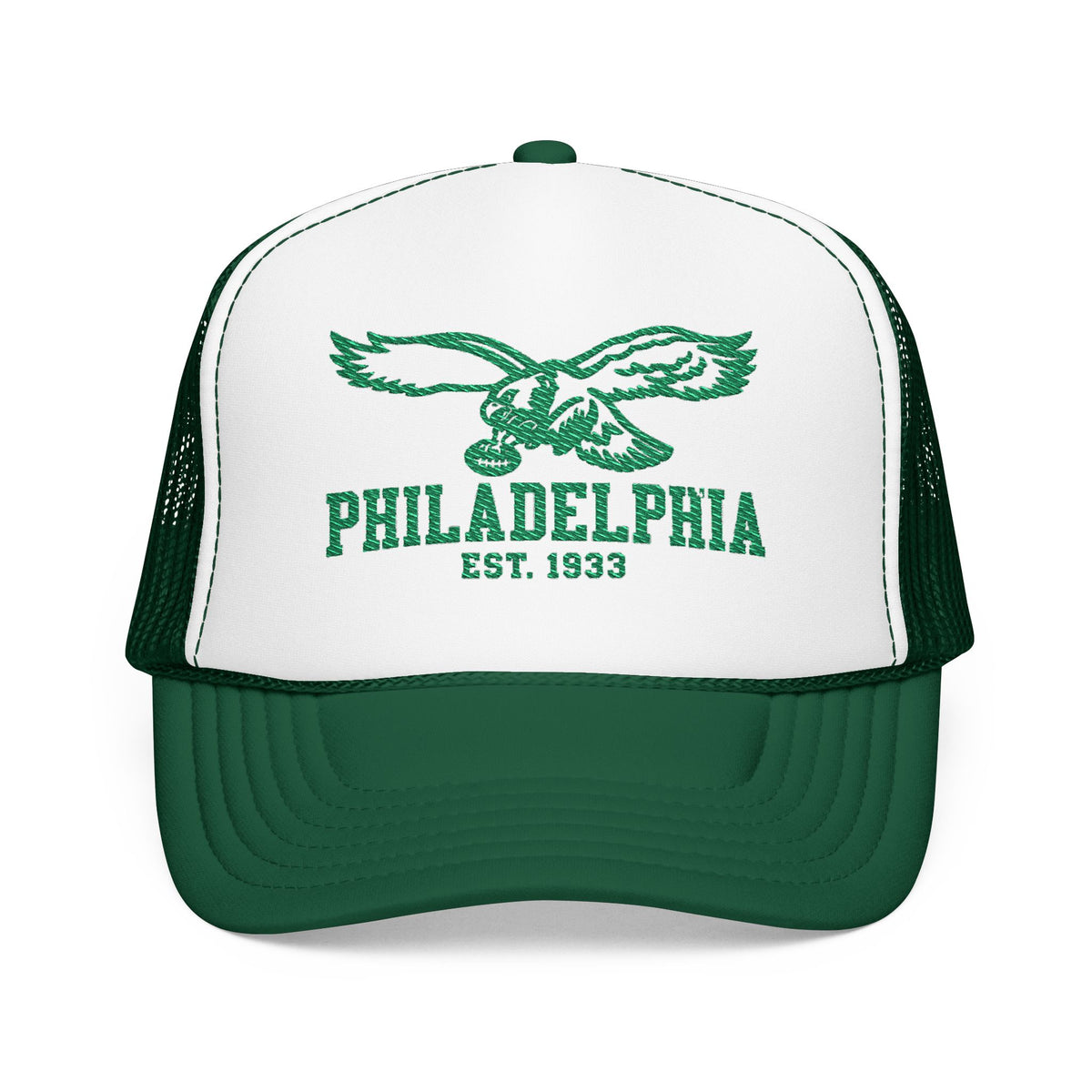 A Philadelphia trucker hat with a white front panel, green brim, and green mesh back. The front panel features a green eagle graphic above the text 'PHILADELPHIA EST.