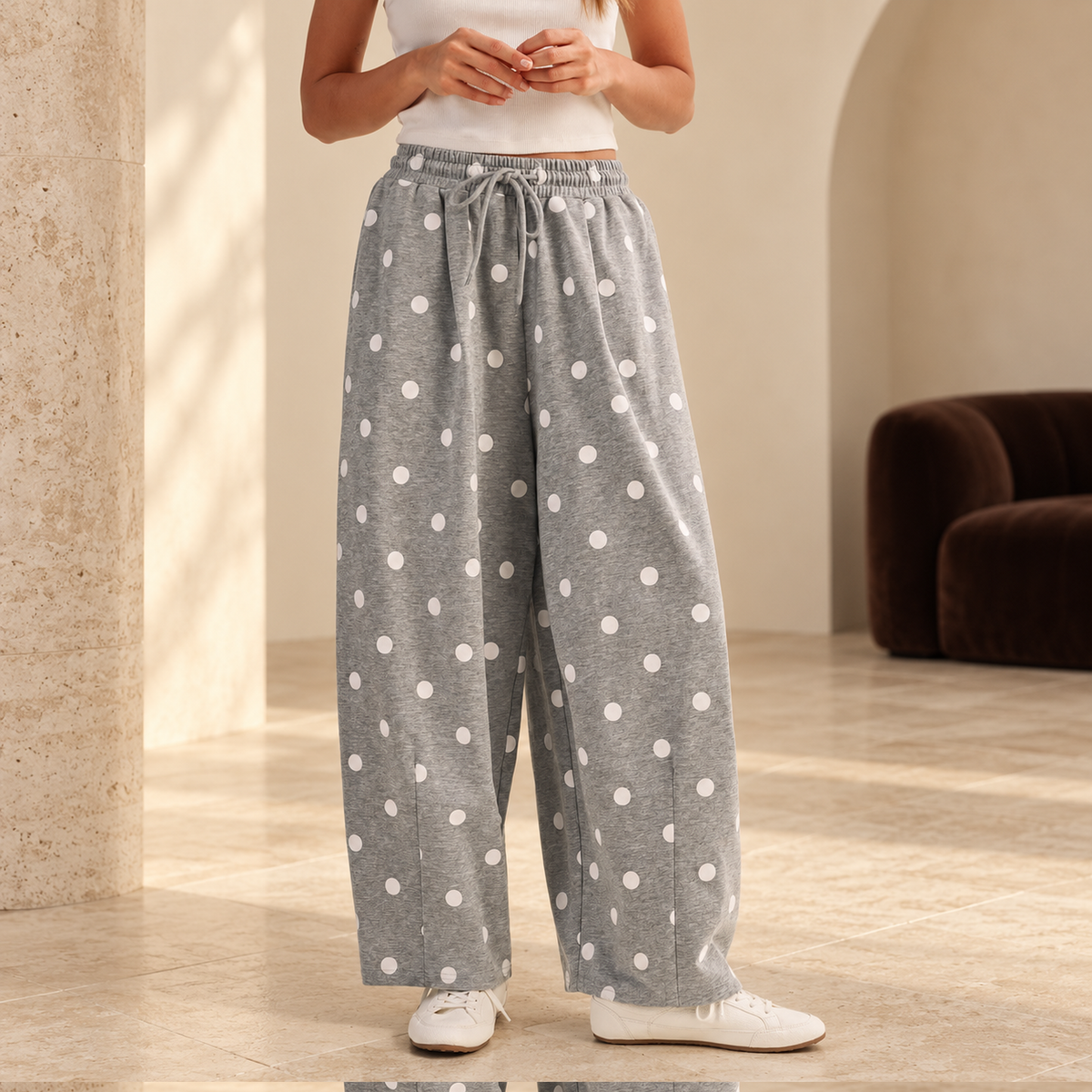 Cloud Dot heather-grey barrel-leg sweatpants with white polka dots in a warm cream studio