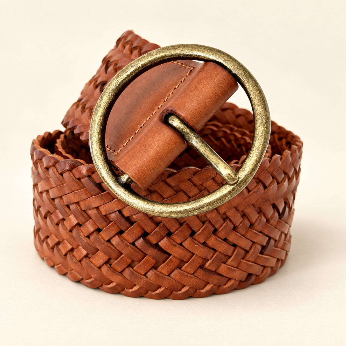 Heritage Cognac Braided Leather Belt on a warm ivory background