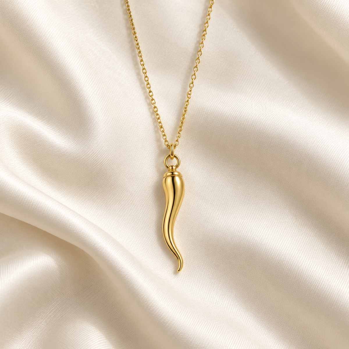 Gold-tone Italian horn pendant necklace on ivory fabric