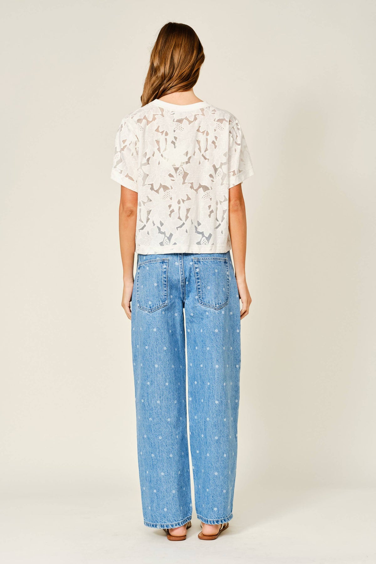Back view of the off-white Soft Bloom Floral Lace Tee showing all-over floral lace and a straight hem