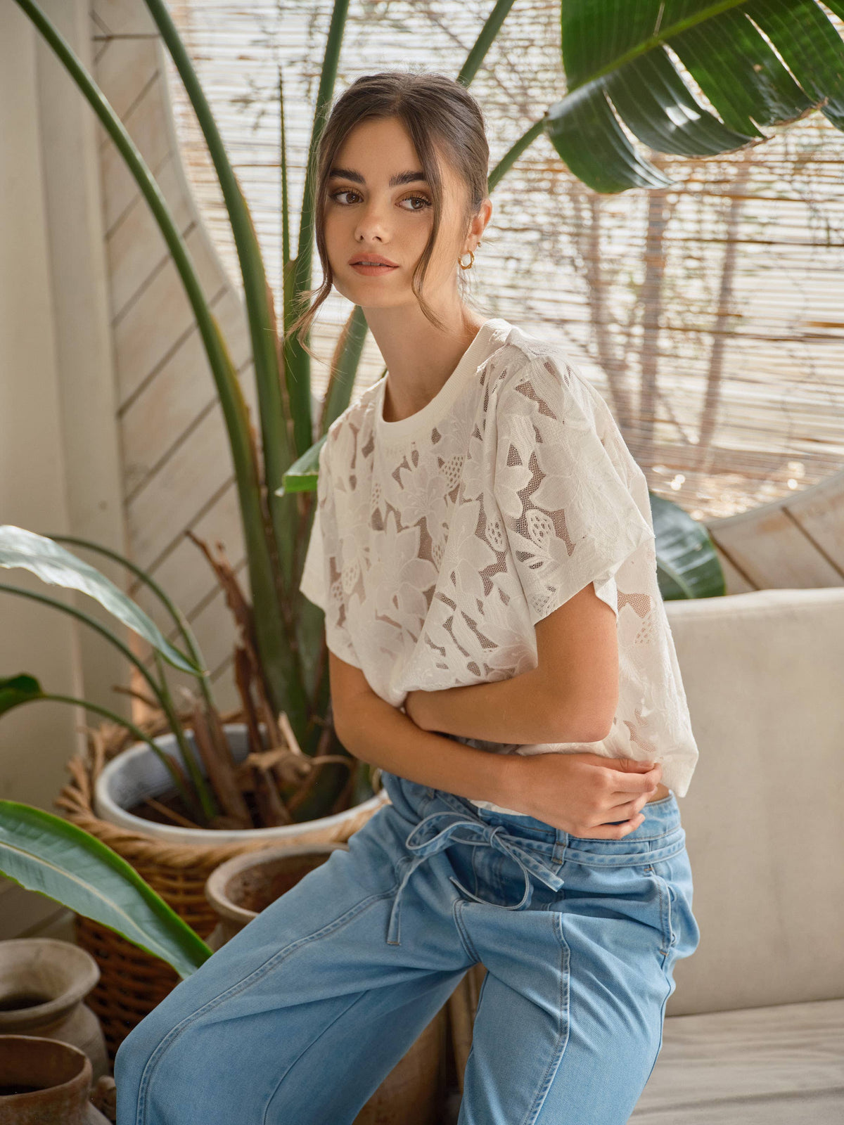Side detail of the off-white Soft Bloom Floral Lace Tee showing its floral mesh, loose short sleeve and relaxed fit