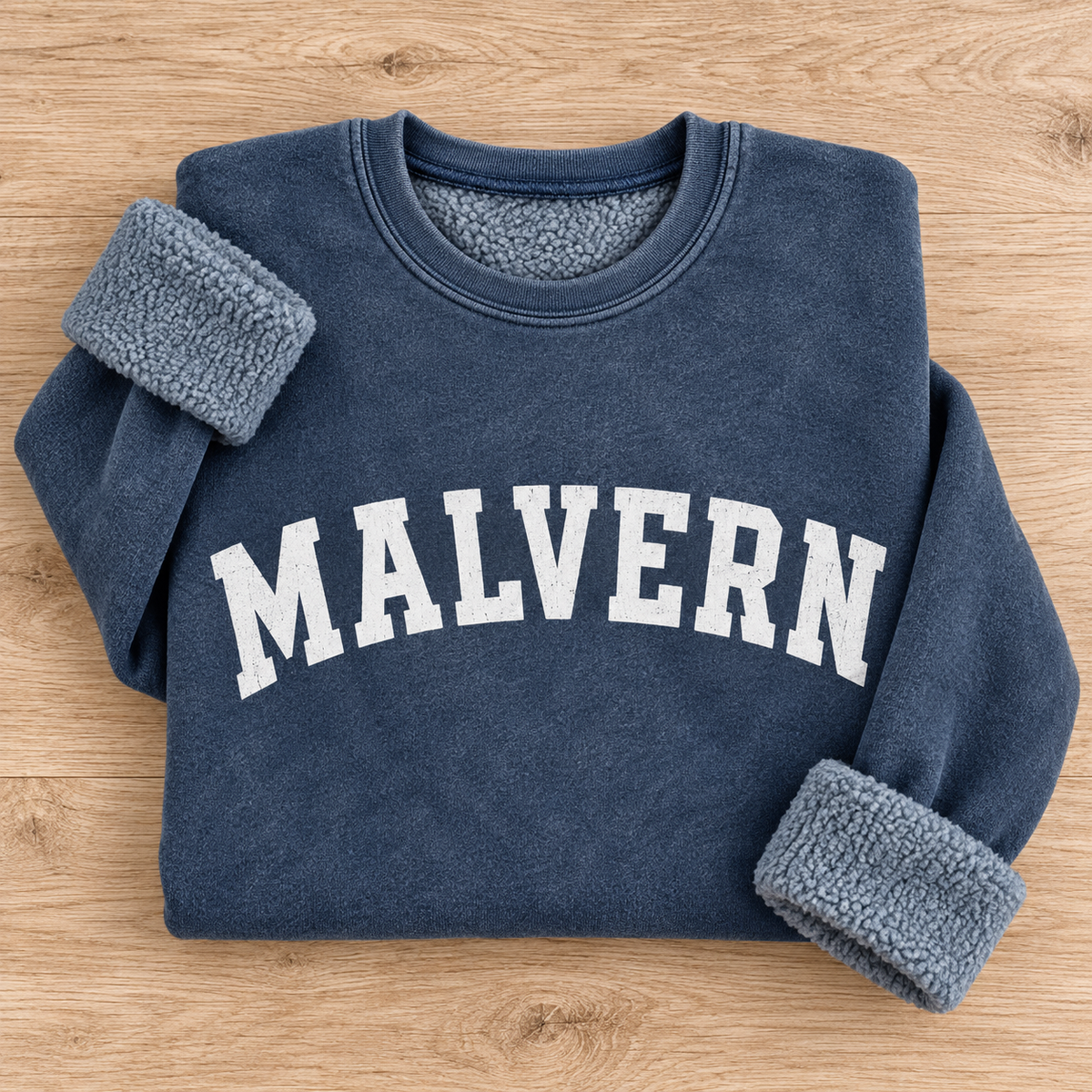 Flat lay of mineral navy MALVERN sweatshirt showing white collegiate lettering and sherpa lining | House of Caelo