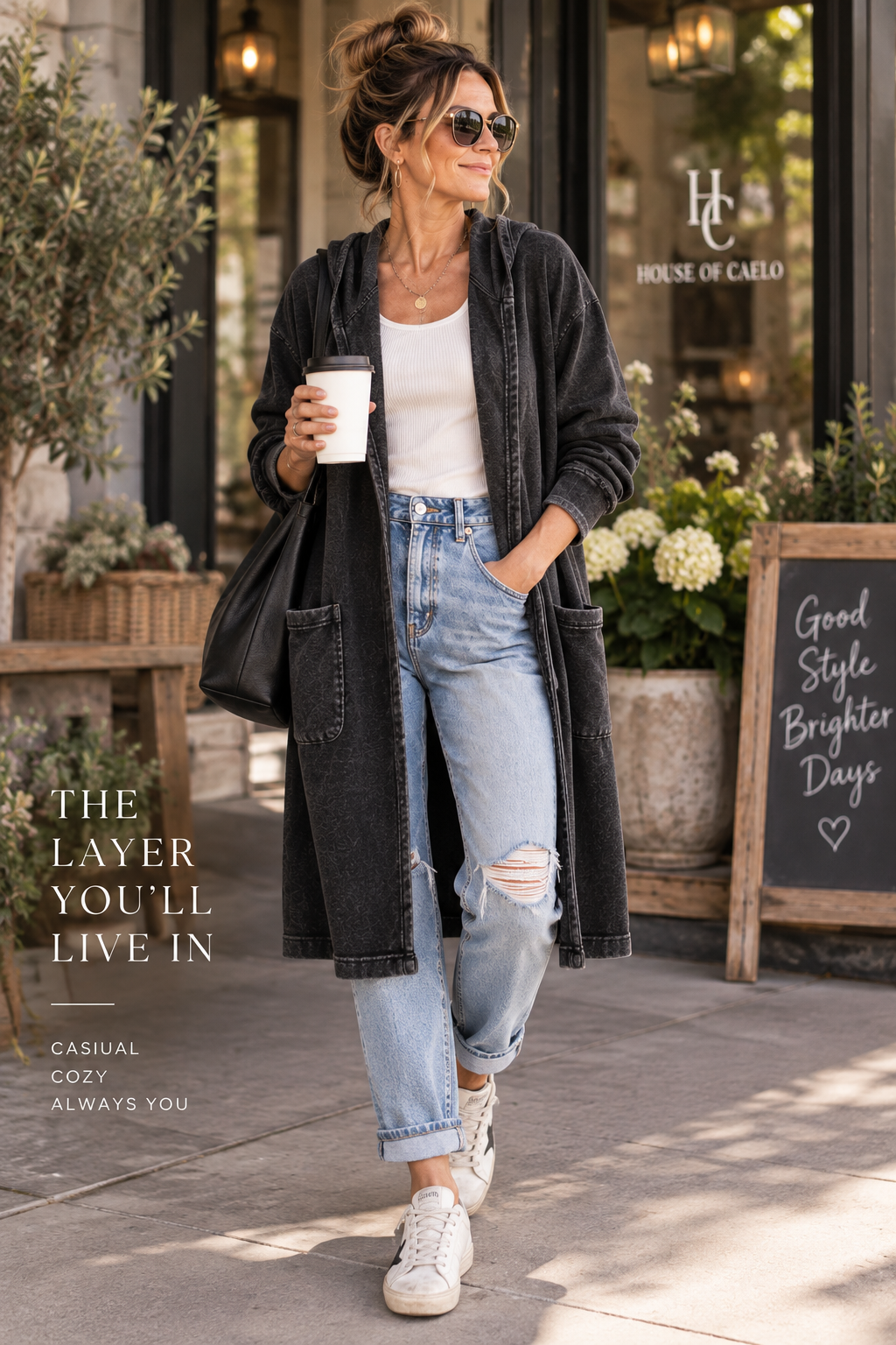 Woman wearing the House of Caelo black mineral wash longline hooded cardigan