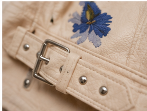 Wildflower Studded Faux Leather Moto Jacket belt and blue floral embroidery detail