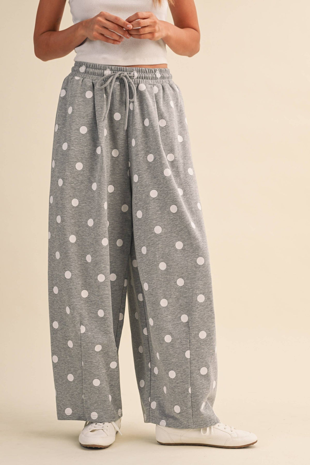 Front view of heather-grey Cloud Dot barrel-leg sweatpants with white polka dots