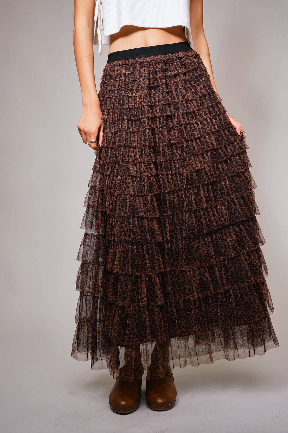 Front view of the brown and black leopard tiered ruffle maxi skirt with a black elastic waistband