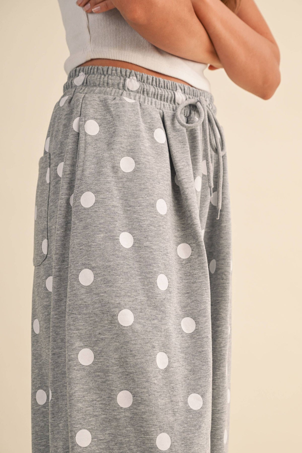 Close-up of the elastic waist, drawstring, side pocket, and white polka-dot print