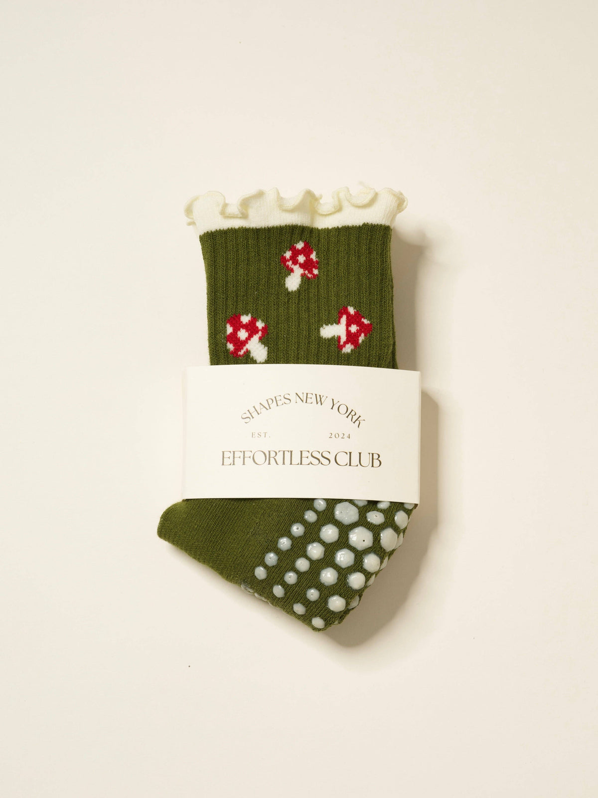 Packaged olive mushroom ruffle grip socks with non-slip sole visible