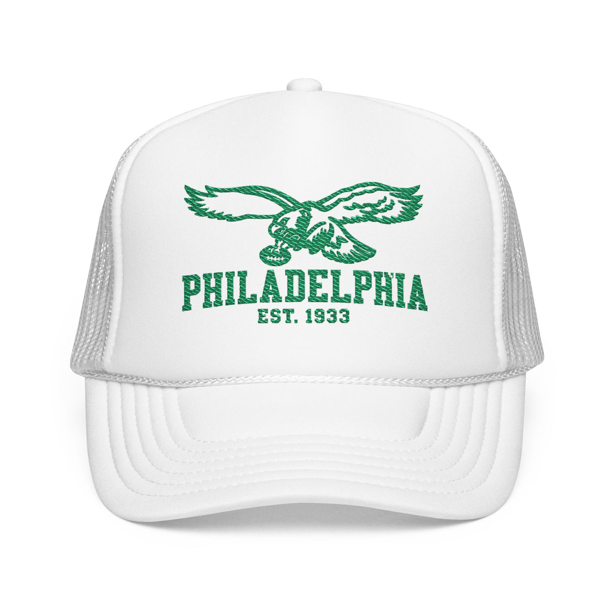 A white trucker hat with green embroidered graphics on the front panel, featuring an eagle and the text 'PHILADELPHIA EST. 1933'.