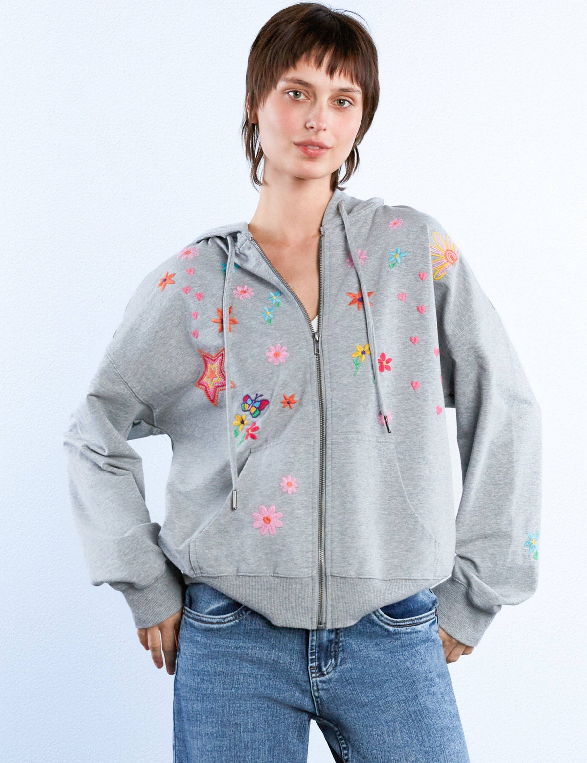 Gray zip-up hoodie with hand-drawn embroidered flowers, hearts, and stars