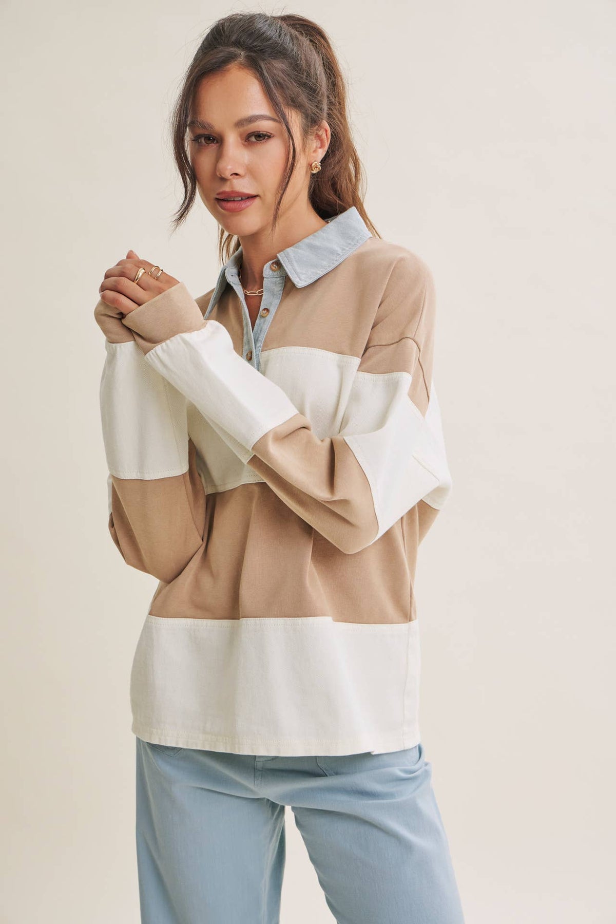 Latte and cream striped rugby top showing the long sleeves and contrast cuffs.