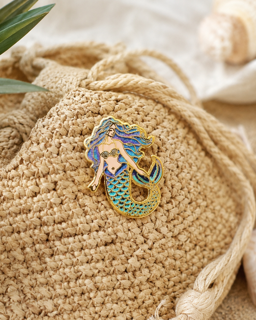 Coral Reef Mermaid enamel pin styled on a woven bag