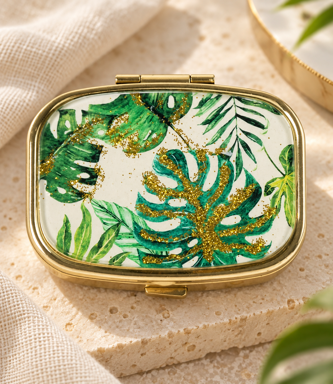 Tropical Leaves Gold-Accent Pill Box — styled product photograph