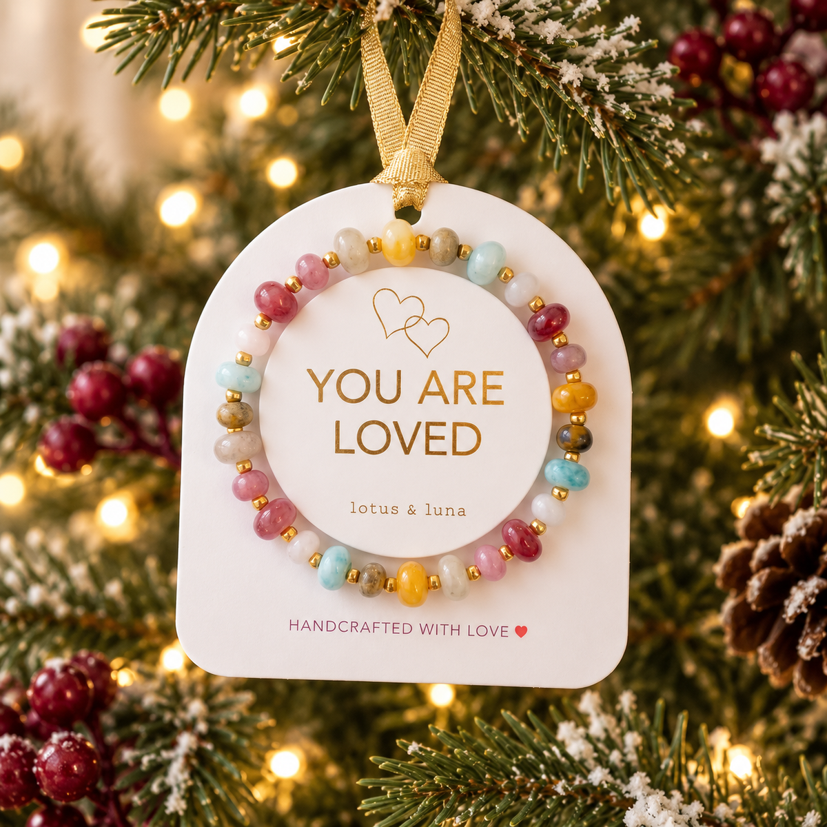 You Are Loved ornament bracelet displayed on a Christmas tree